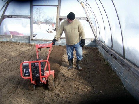 Scott tilling the hoophouse in February